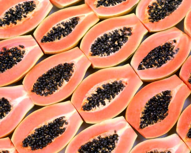 Halved papaya fruits background.