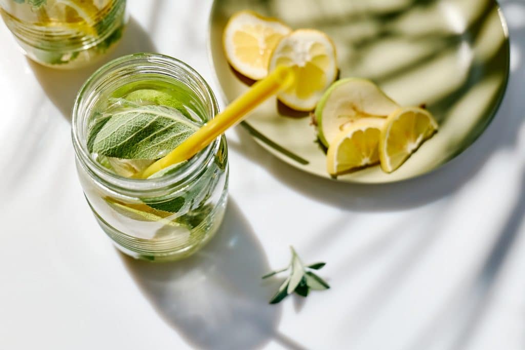 Detox drink. Infused water with pear, lime and sage. Refreshing summer homemade cocktail.
