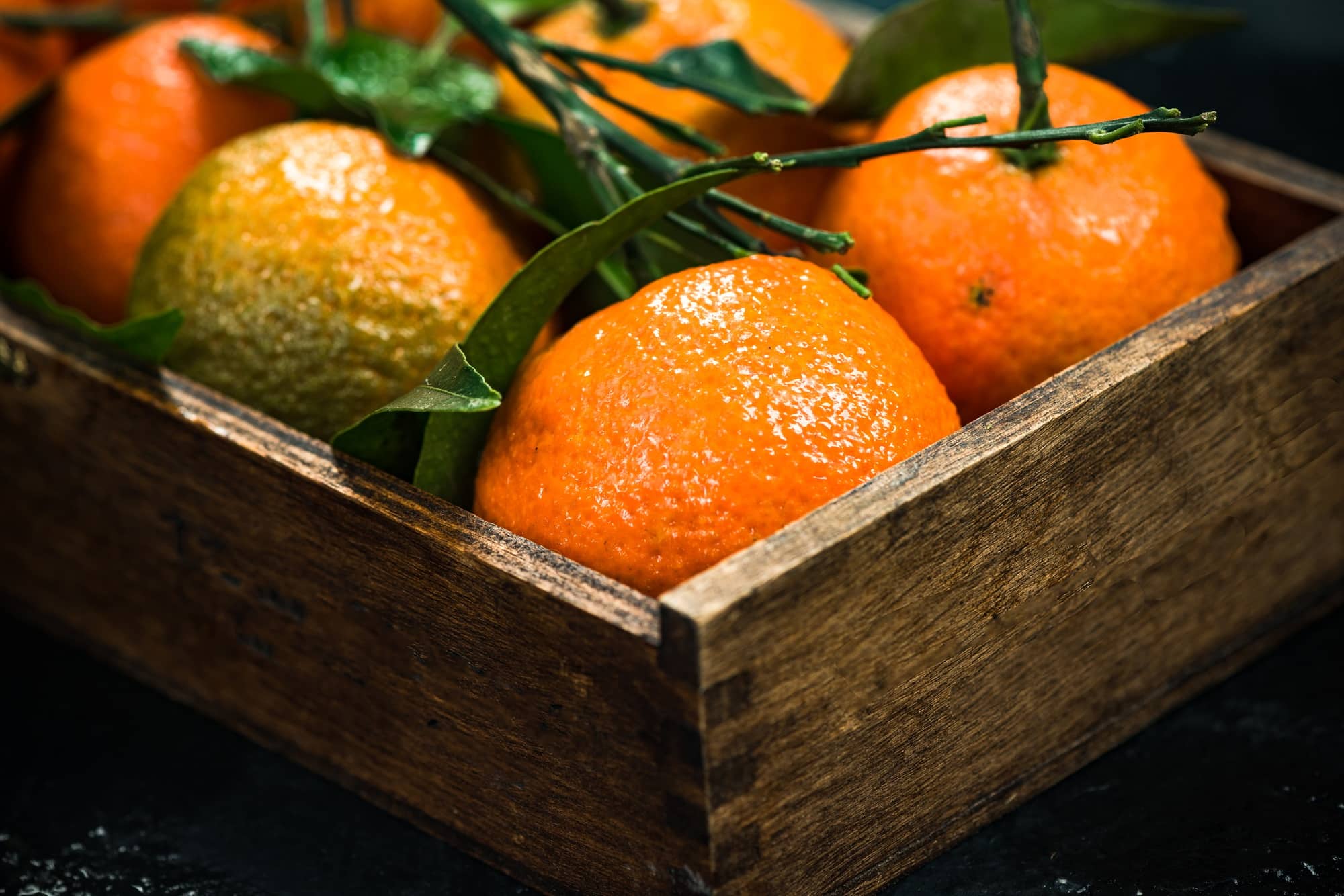Tangerines or clementines in wooden crate